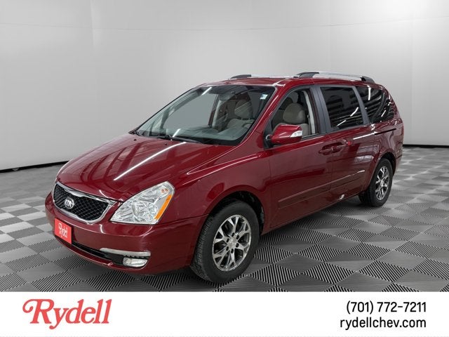 2014 Kia Sedona LX in Claret Red — front three-quarter view